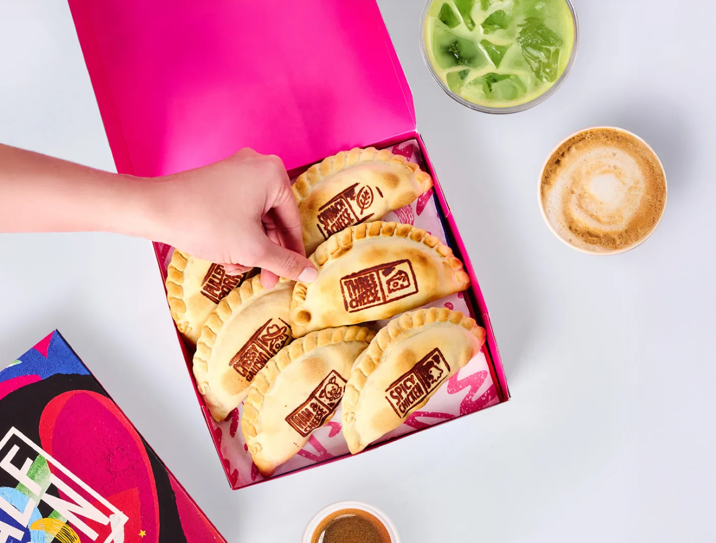 Box of fresh empanadas with coffee drinks